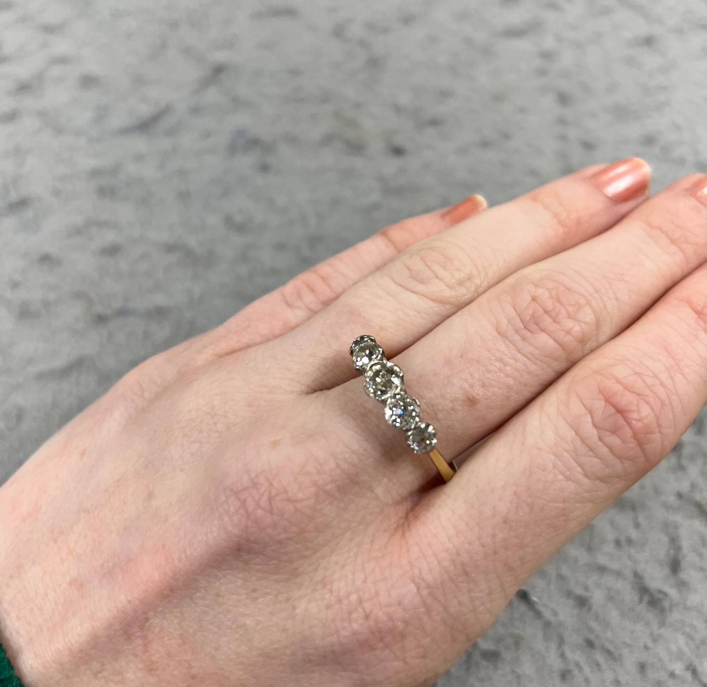 An antique yellow metal and graduated old round cut diamond set half hoop ring, size Q, gross weight 4 grams.